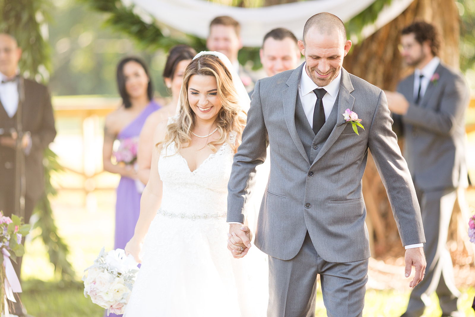 Couple smiling holding hands at a robbins lodge wedding